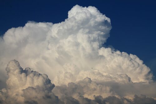 Große weiße Wolken, die sich vor dunkelblauem Himmel türmen